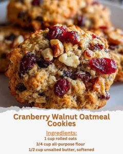Freshly baked cranberry walnut oatmeal cookies on a cooling rack.