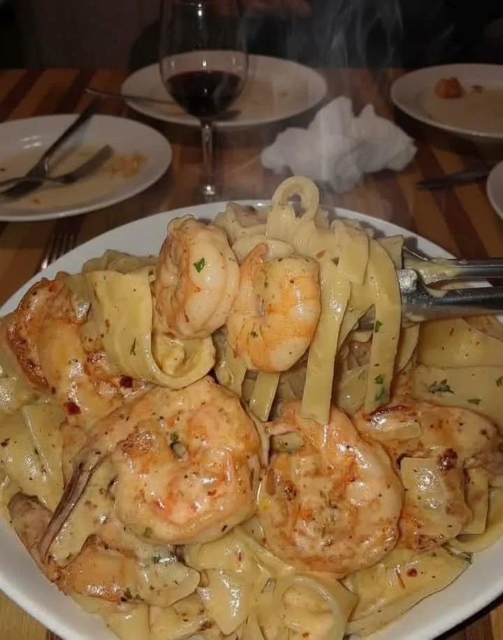 Delicious creamy Cajun shrimp pasta garnished with herbs