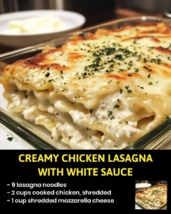 Creamy chicken lasagna with white sauce in a baking dish.