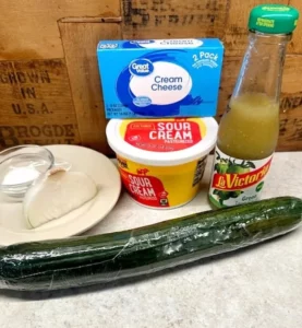 Creamy cucumber salad with fresh herbs and dressing in a bowl