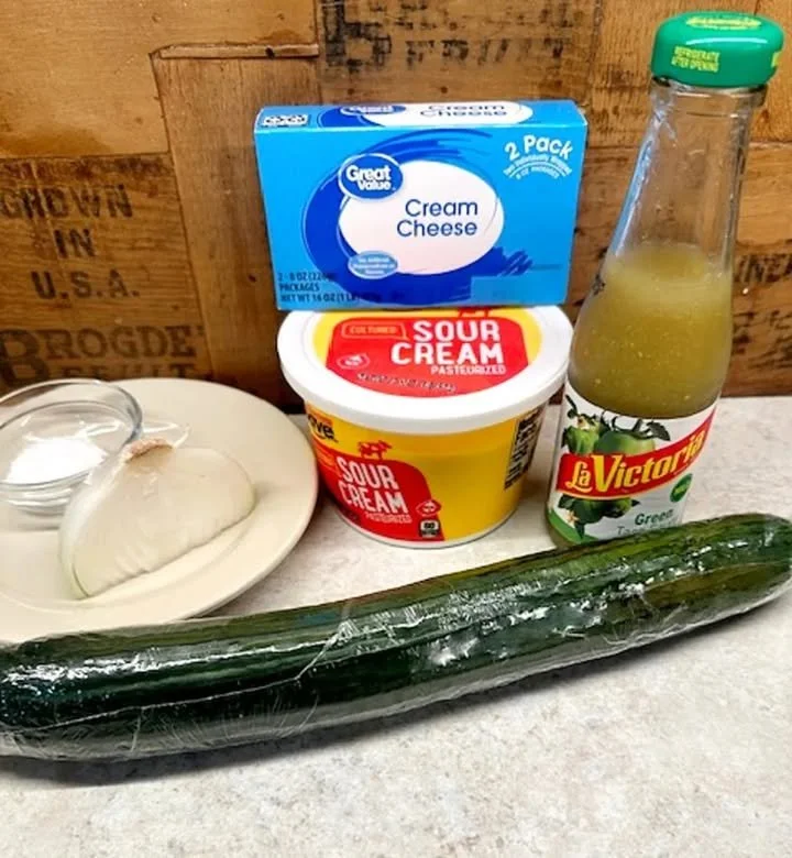 Creamy cucumber salad with fresh herbs and dressing in a bowl