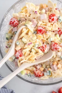 Creamy pasta salad with fresh vegetables and dressing in a bowl