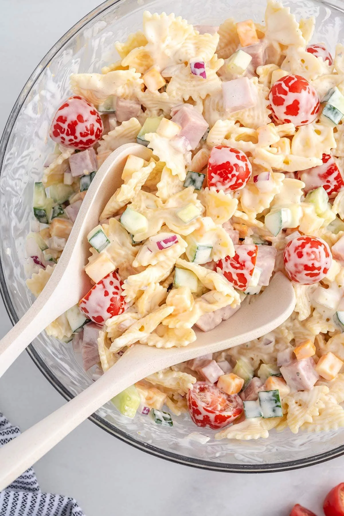 Creamy pasta salad with fresh vegetables and dressing in a bowl
