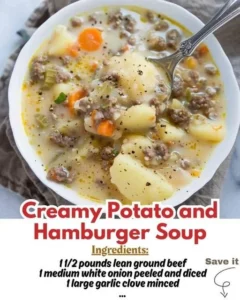 Bowl of creamy potato hamburger soup topped with herbs and served with bread