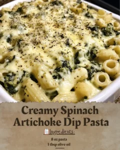 Creamy spinach artichoke dip pasta in a bowl garnished with herbs.