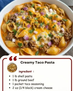 Delicious creamy taco pasta topped with cheese and herbs, perfect for dinner.