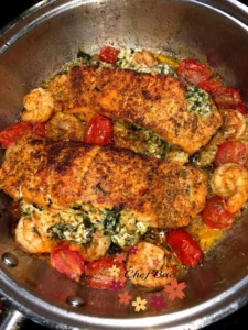 Delicious creamy Tuscan salmon served with herbs and vegetables.