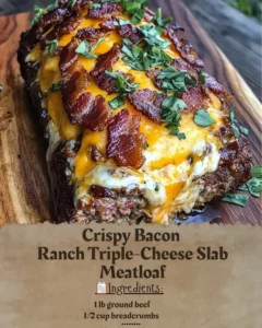 Crispy Bacon Ranch Triple-Cheese Slab Meatloaf served on a rustic wooden board