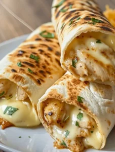 Crispy Cheesy Garlic Chicken Wraps served with dipping sauce on a plate