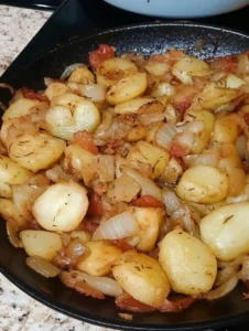 Delicious crispy fried potatoes with onion served in a bowl