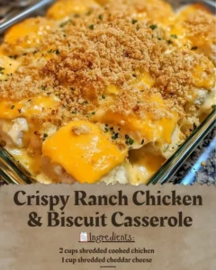 Crispy ranch chicken and biscuit casserole in a baking dish topped with herbs.