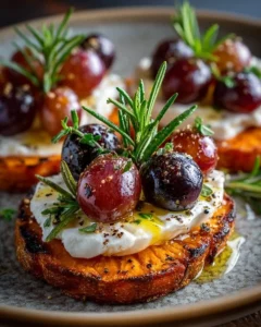 Crispy sweet potato rounds topped with burrata cheese and roasted grapes