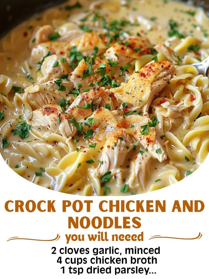 A bowl of Crock Pot Chicken and Noodles garnished with herbs.