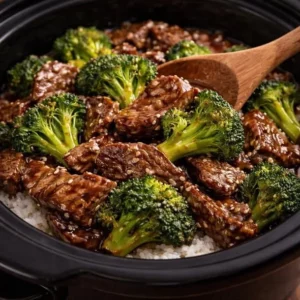 Delicious Crockpot Beef & Broccoli served in a bowl with rice.