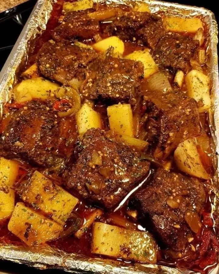 Delicious crockpot beef short ribs served with a side of vegetables.