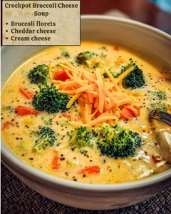 A bowl of creamy Crockpot broccoli cheese soup garnished with herbs.