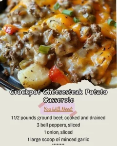Delicious crockpot cheesesteak potato casserole topped with melted cheese
