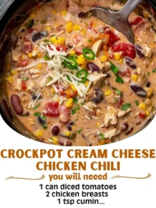 A bowl of Crockpot Cream Cheese Chicken Chili garnished with fresh herbs.