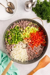 Bowl of Crockpot Creamy Potato and Hamburger Soup with fresh herbs