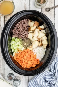Crockpot Creamy Potato and Hamburger Soup served in a bowl with fresh ingredients.