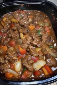 Crockpot pepper steak served with vegetables on a plate
