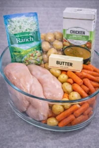 Crockpot Ranch Chicken served with potatoes in a rustic dish