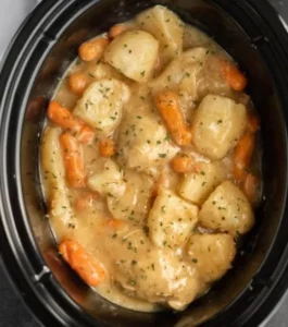 Crockpot Ranch Chicken and Potatoes dish with fresh herbs and vegetables.
