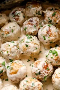 Crockpot Swedish meatballs served with gravy and parsley garnish