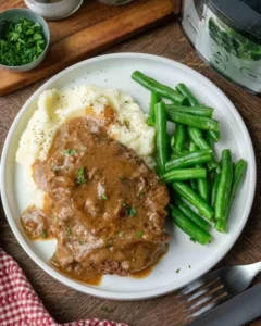 Plate of tender cube steak served with rich brown gravy