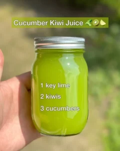 Freshly made Cucumber Kiwi Juice in a glass with cucumber slices and kiwi.