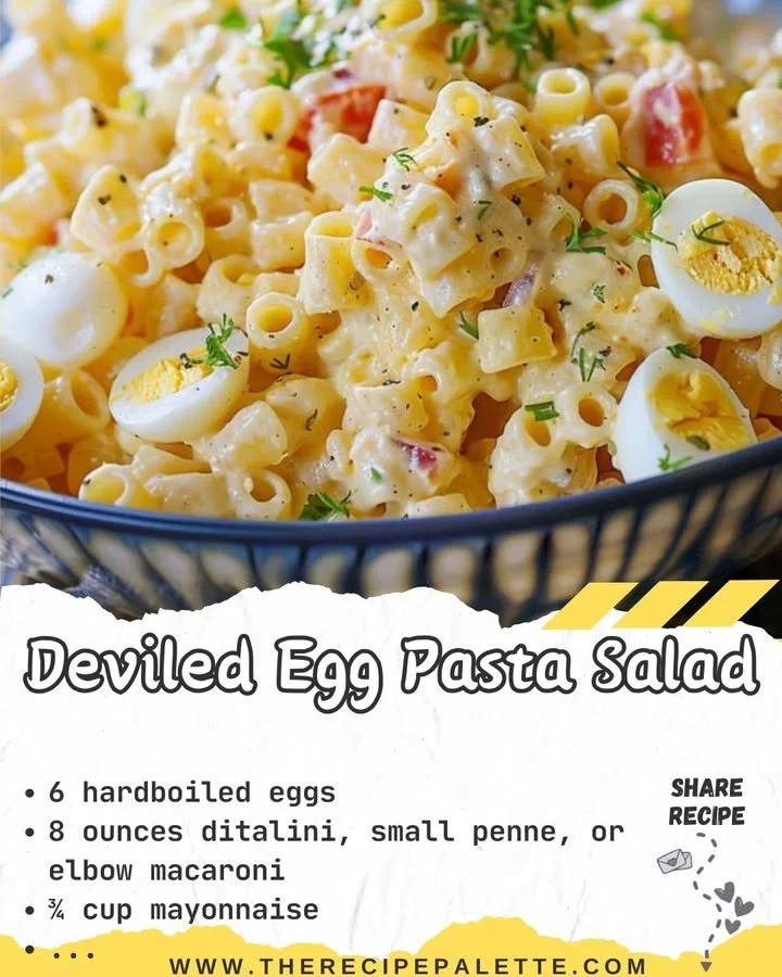Bowl of deviled egg pasta salad with garnishes on a wooden table