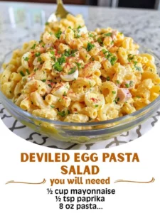 Delicious deviled egg pasta salad in a bowl, garnished with herbs.