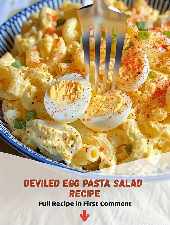 Bowl of Deviled Egg Pasta Salad garnished with herbs.