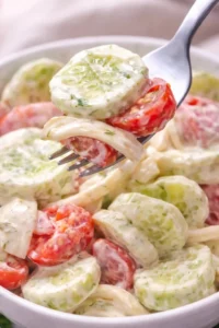 Dill cucumber salad in a bowl garnished with fresh dill and slices of cucumber.