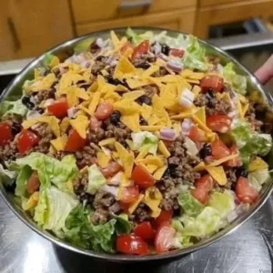 Delicious Dorito Taco Salad served in a bowl with colorful toppings and Doritos.
