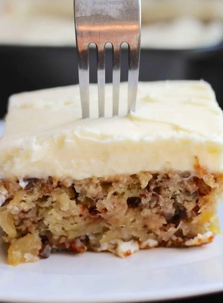 Family favorite cake topped with frosting and colorful sprinkles.