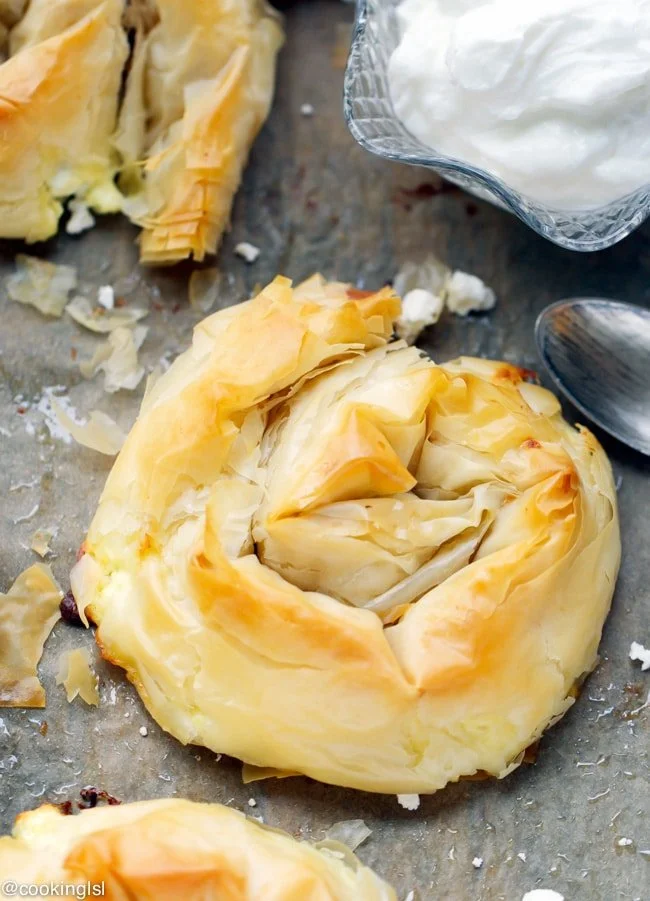 Crispy filo and feta swirls on a serving platter
