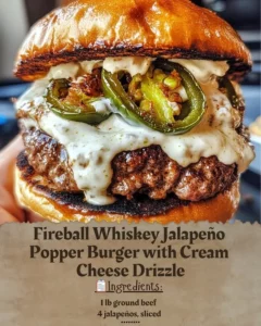 Fireball Whiskey Jalapeño Popper Burger with cream cheese drizzle on a plate