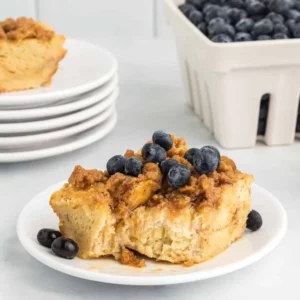 Delicious French Toast Casserole served with syrup and berries on a plate