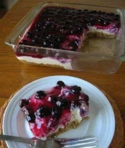 Fresh blueberry cheesecake with a homemade crust topped with ripe blueberries