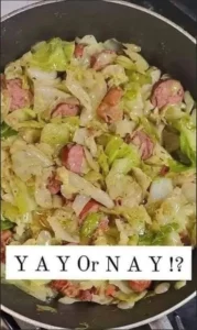Plate of fried cabbage with crispy bacon pieces garnished with green onions