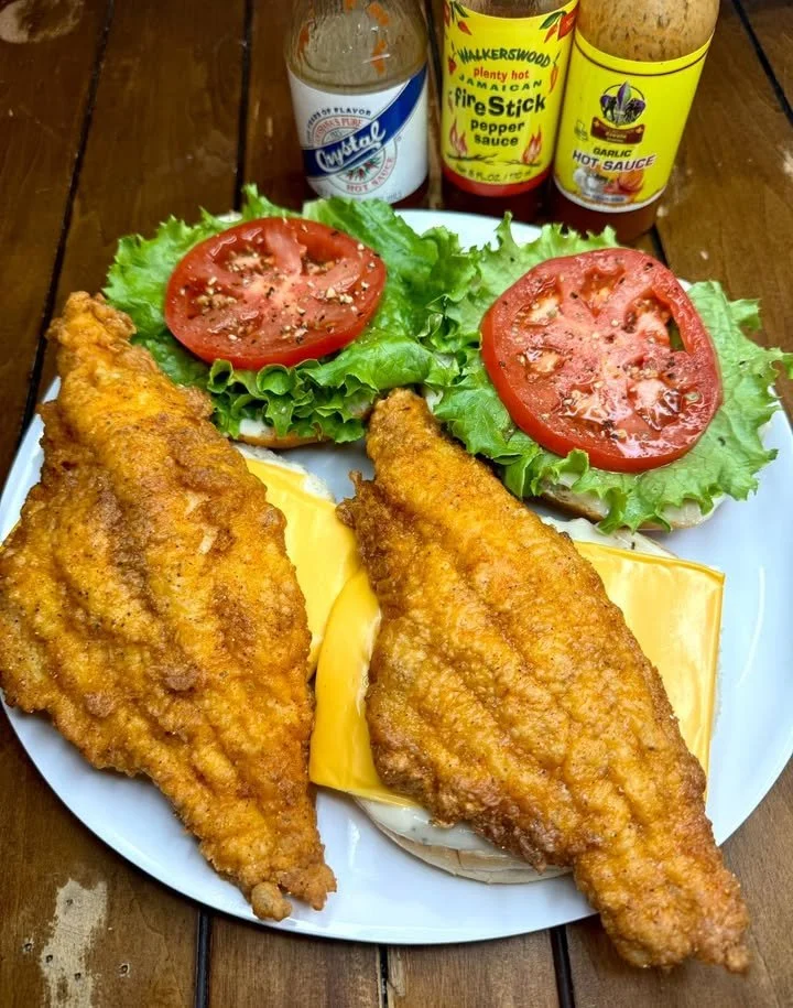 Delicious fried catfish sandwich with lettuce and tartar sauce on a bun