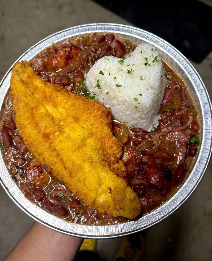 Delicious fried catfish served with red beans and rice on a plate