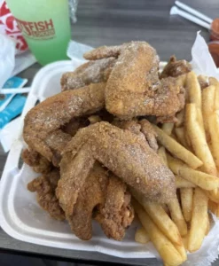 Crispy fried chicken served with side dishes on a wooden table