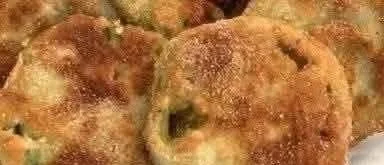 Plate of golden fried green tomatoes with dipping sauce