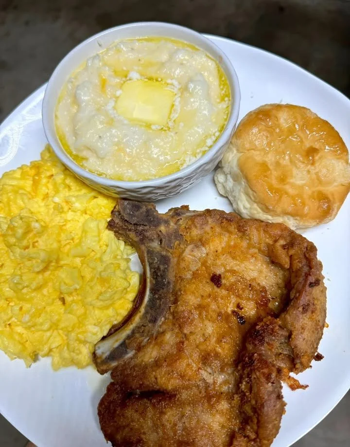 Fried pork chop served with grits for a delicious breakfast.