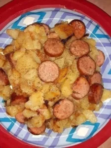Plate of fried potatoes, onions, and smoked Polish sausage dish