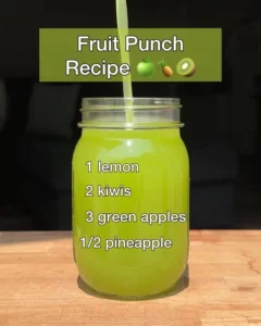 Colorful fruit punch with various fruits in a glass pitcher