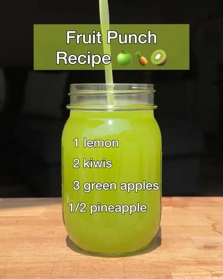 Colorful fruit punch with various fruits in a glass pitcher