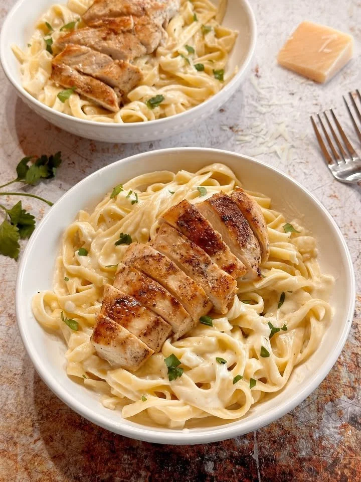 Delicious garlic butter rotisserie chicken served with creamy garlic parmesan fettuccine